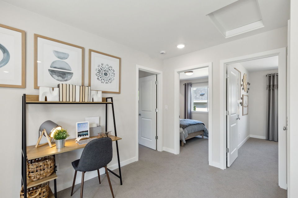 A room with a desk and a bed.