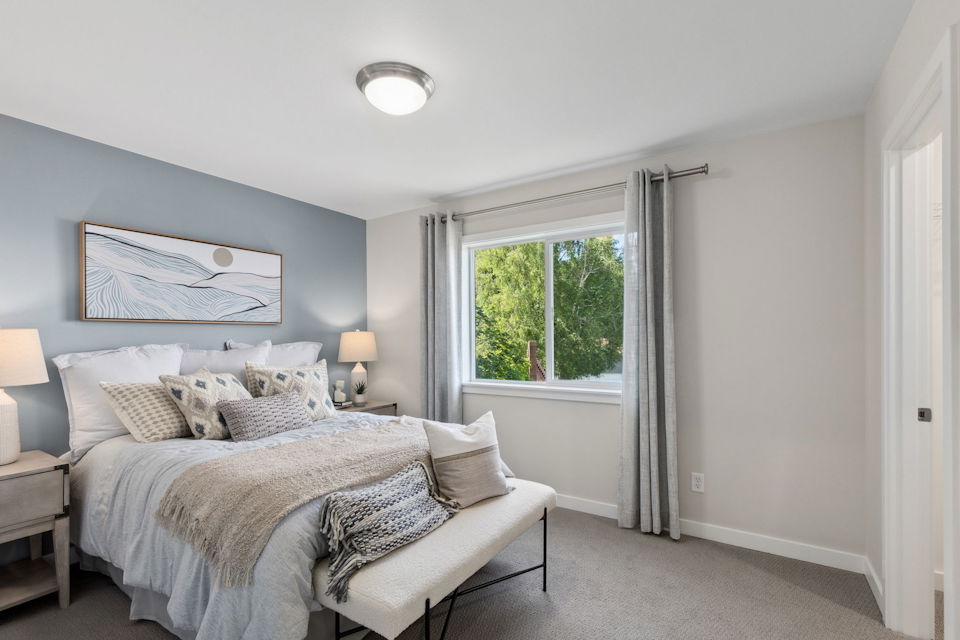 A bedroom with a bed and a window.