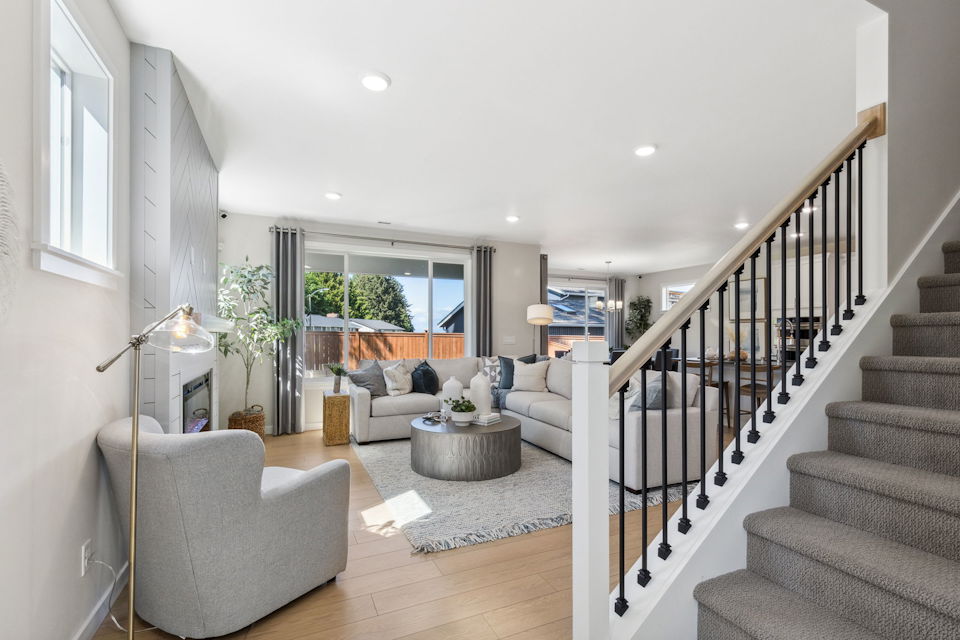 A living room with a staircase.
