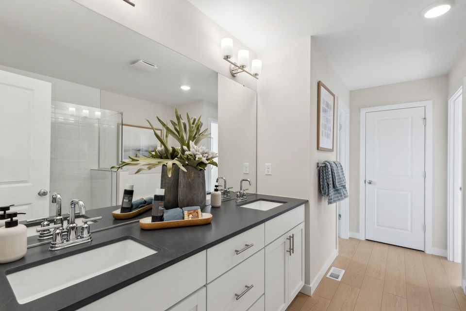 A bathroom with a large mirror.