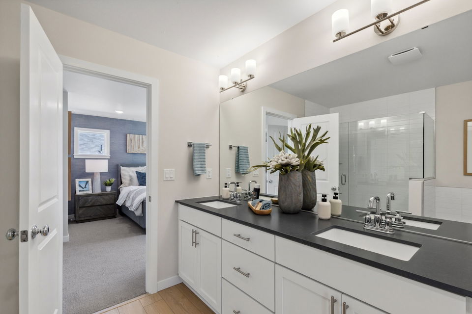 A bathroom with a large mirror.