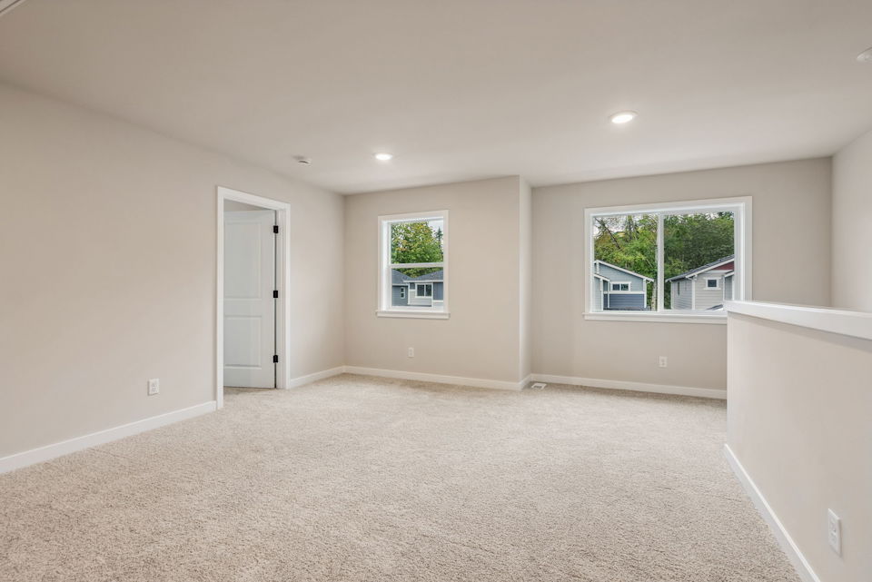 A room with a white floor and windows.