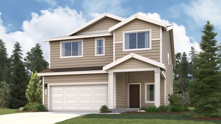 A house with a garage and trees in the back.