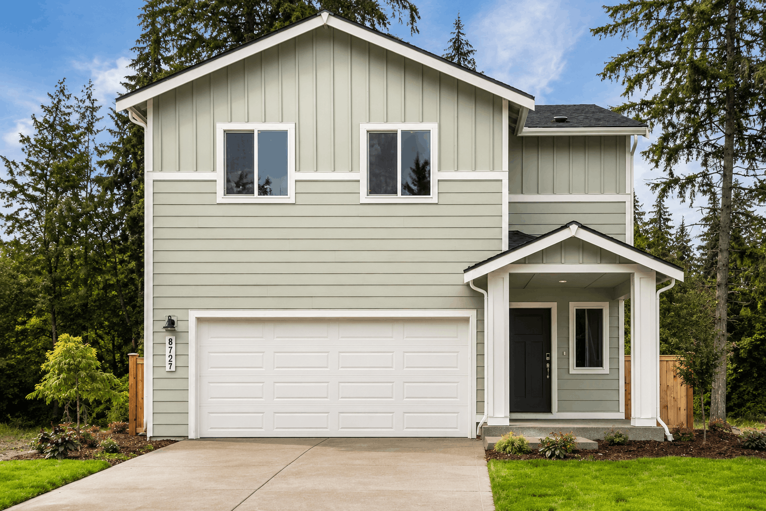 A white house with a garage.