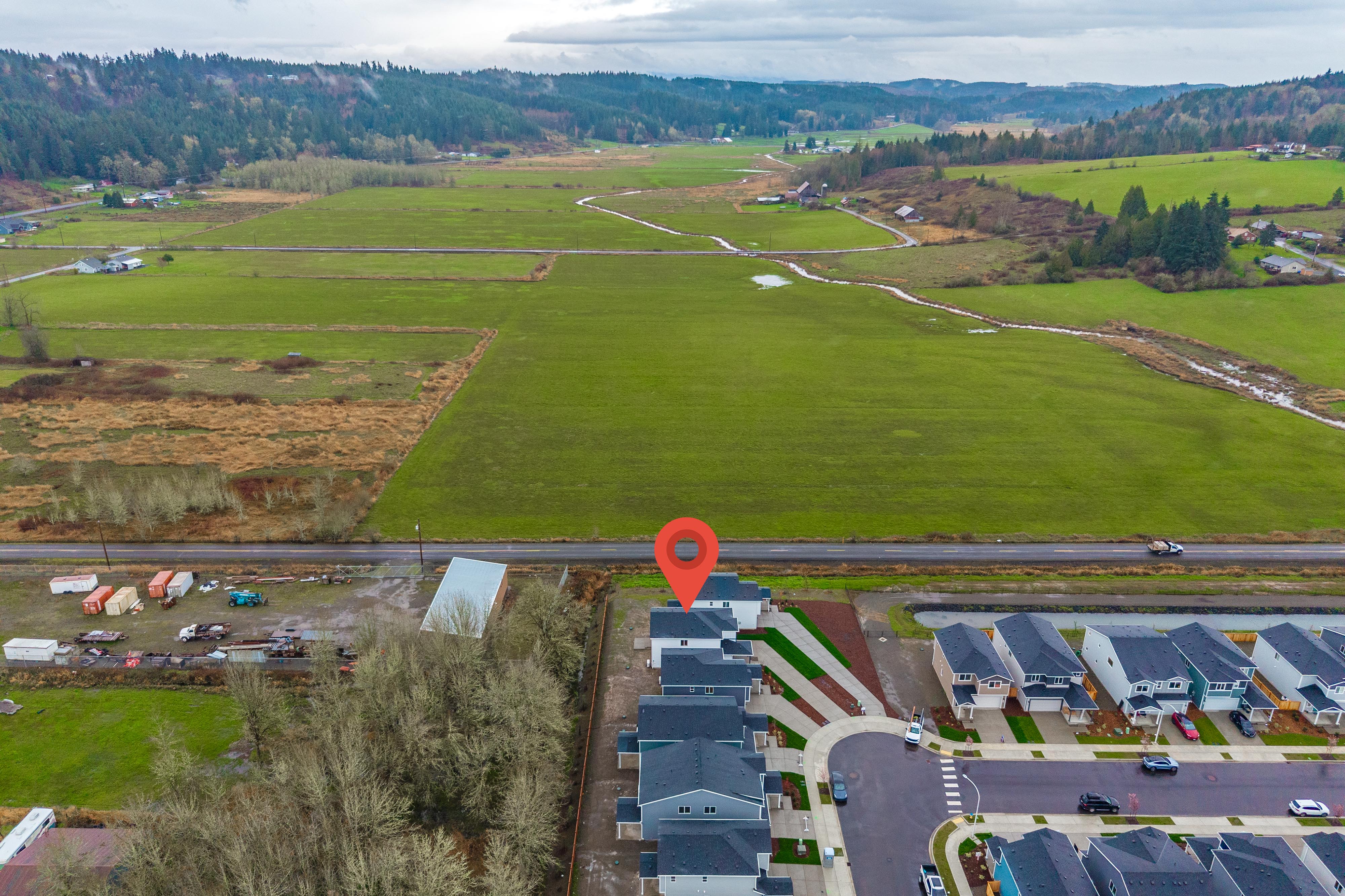 A large field with a few buildings.