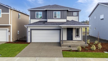 A house with garages and a driveway.