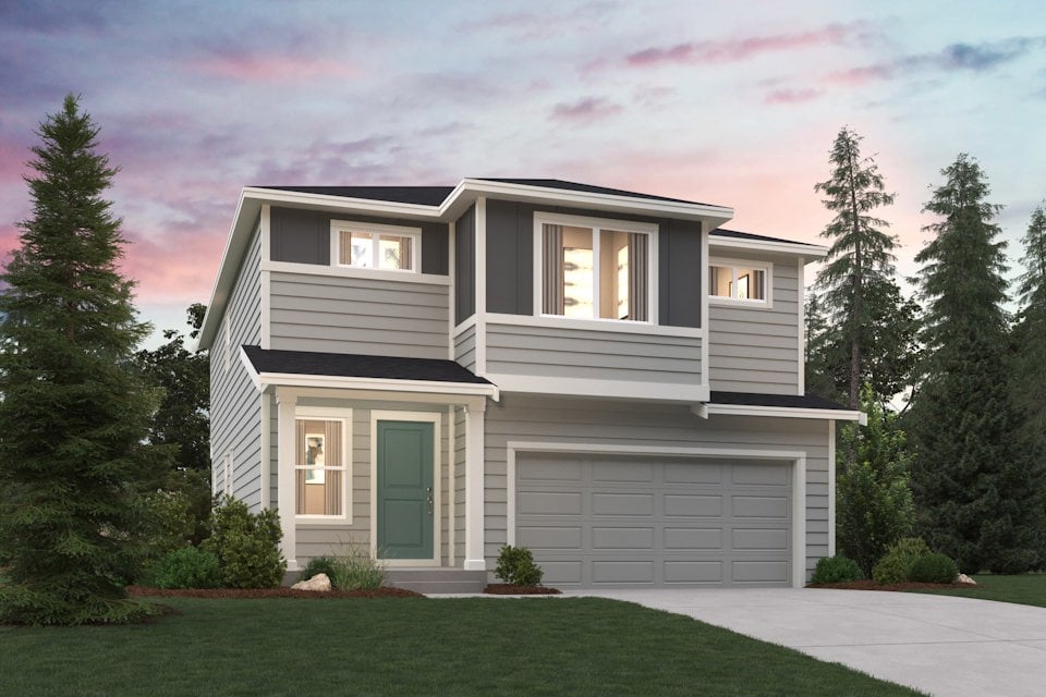 A house with a garage and trees.