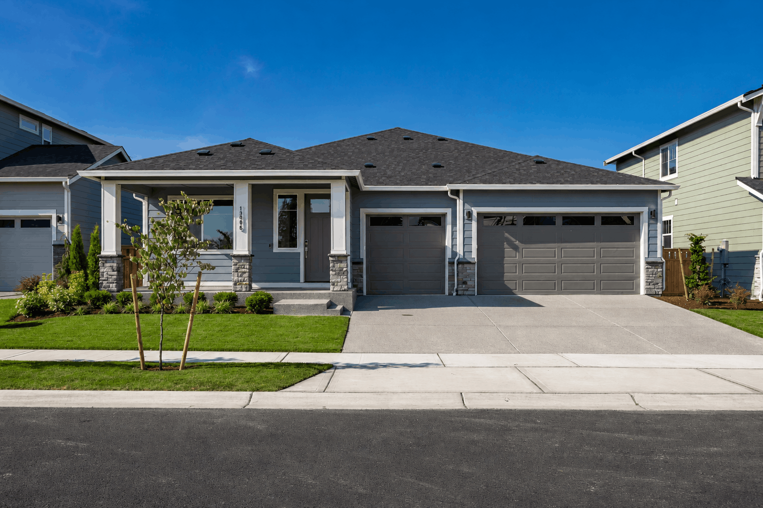 A house with garages and a driveway.