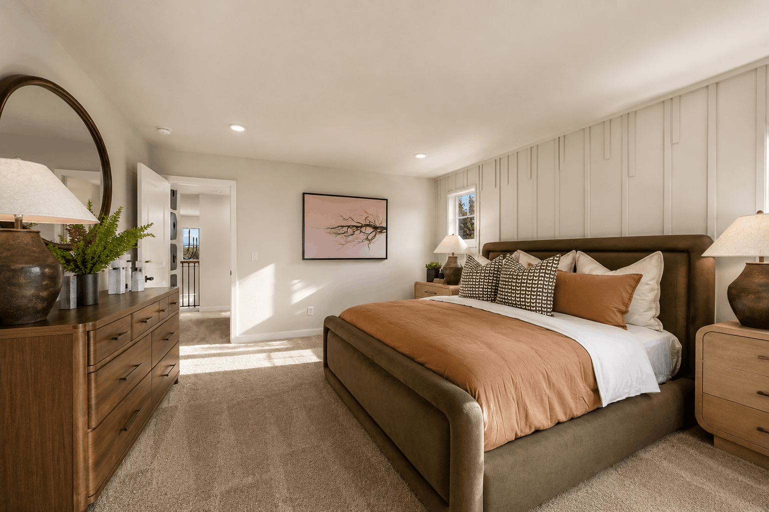A bedroom with a bed and lamps.