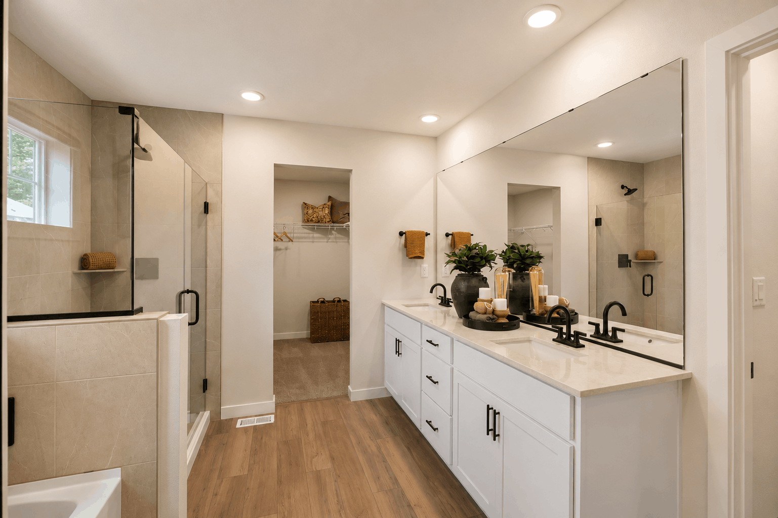 A bathroom with a large mirror.