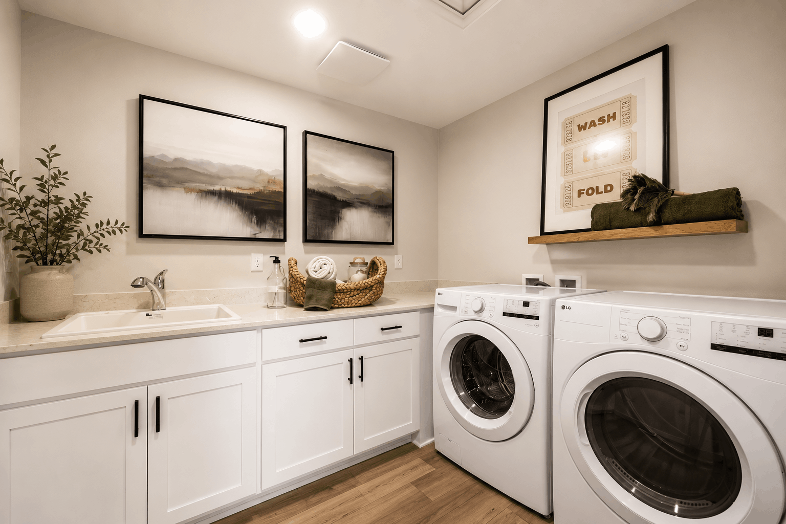 A white kitchen with a washer and dryer.