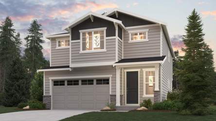 A house with a garage and trees around it.
