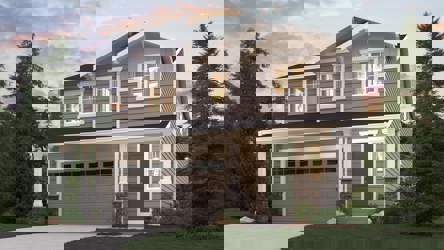 A house with a garage and trees around it.