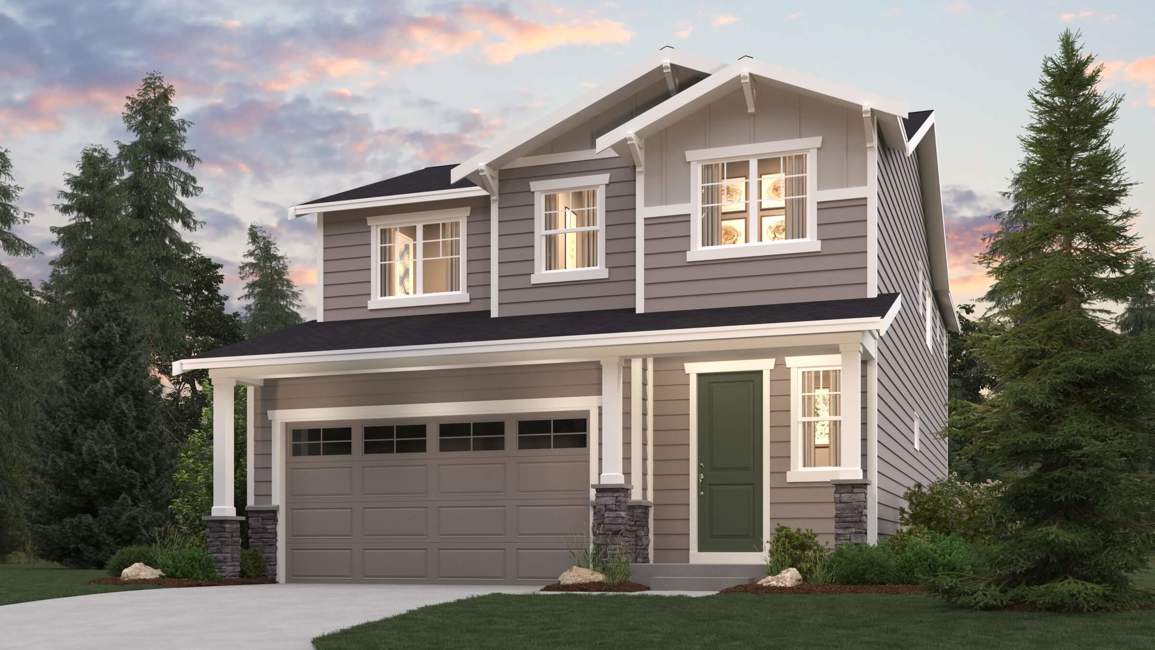 A house with a garage and trees around it.