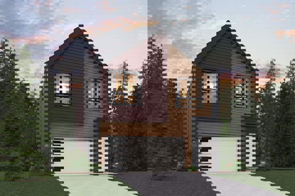 A house with a garage and trees around it.