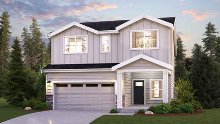 A house with a garage and trees around it.