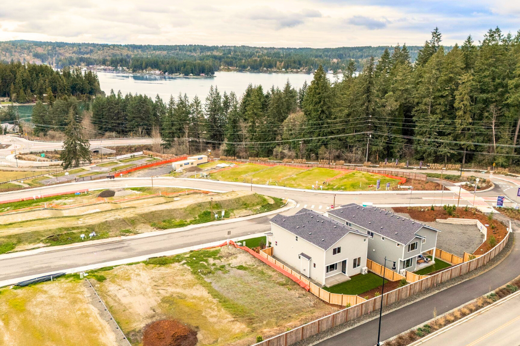 A house with a road and trees in the background.