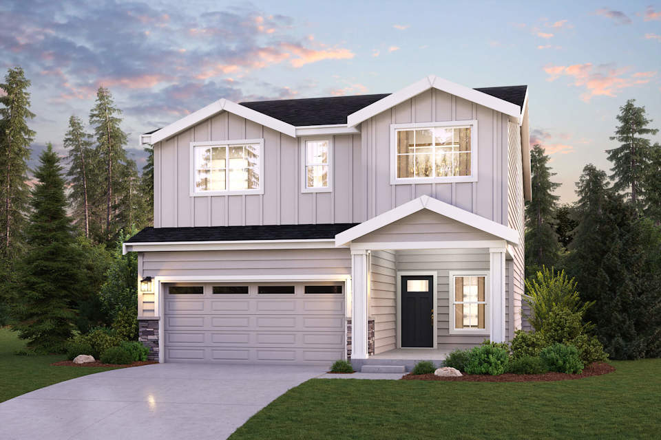 A house with a garage and trees around it.