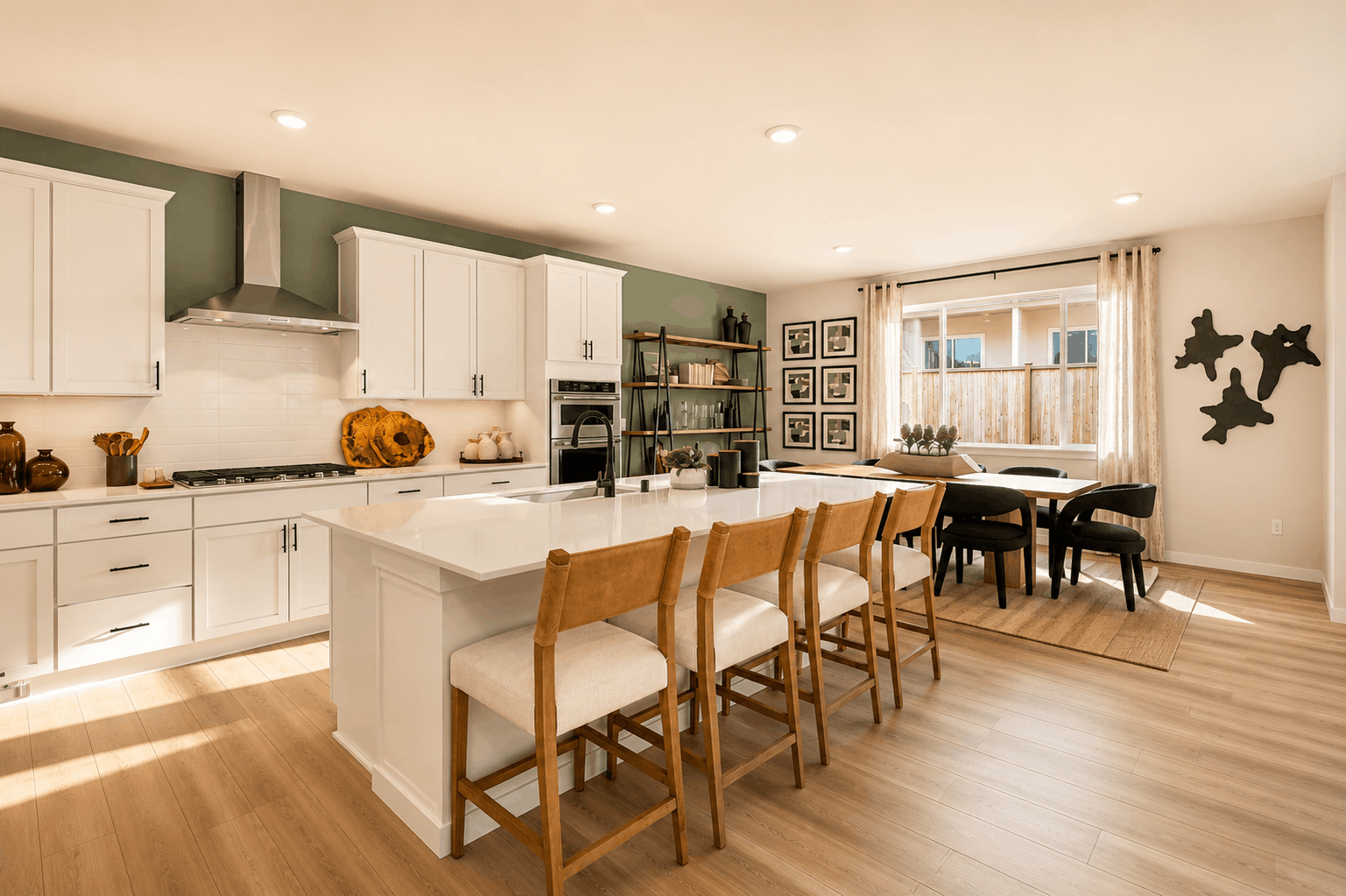 A kitchen with a dining table and chairs.