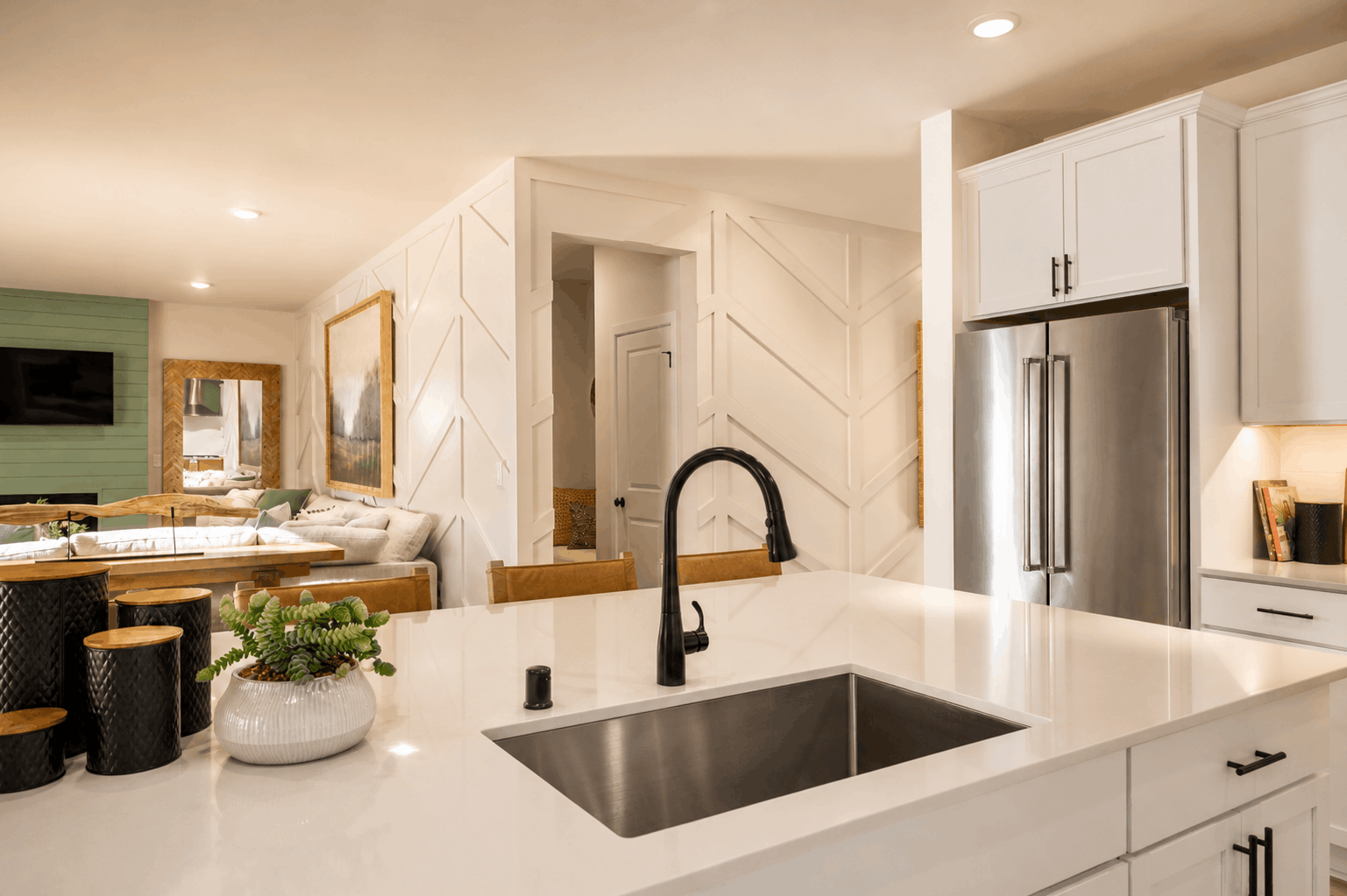 A kitchen with white cabinets.