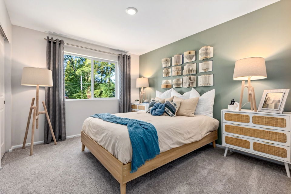 A bedroom with a bed and a window.