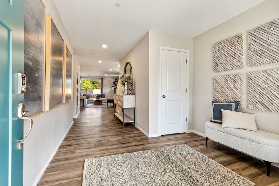 A living room with a rug.