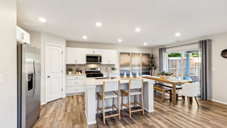 A kitchen with a wood floor.