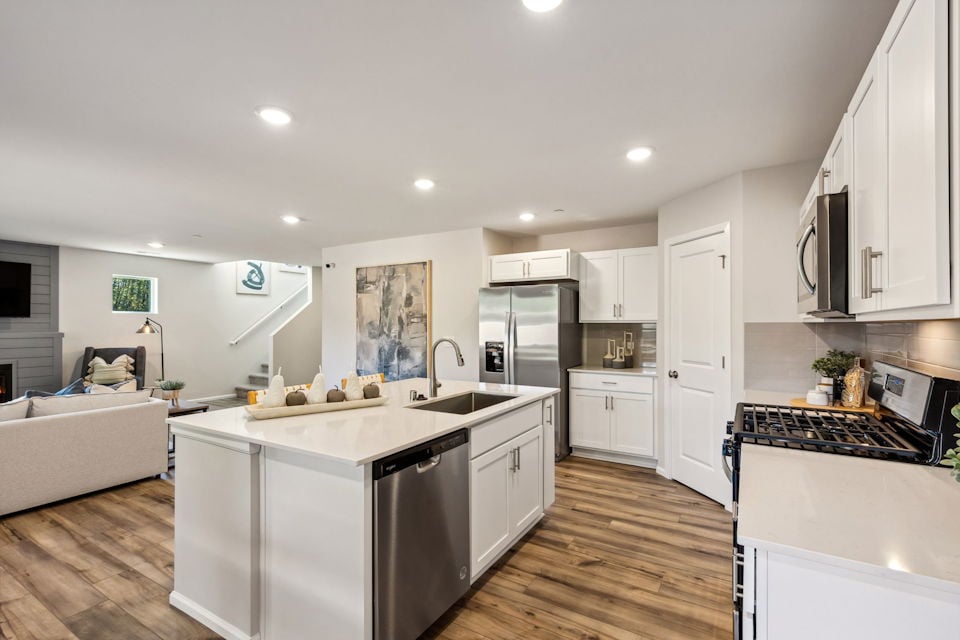 A kitchen with white cabinets.