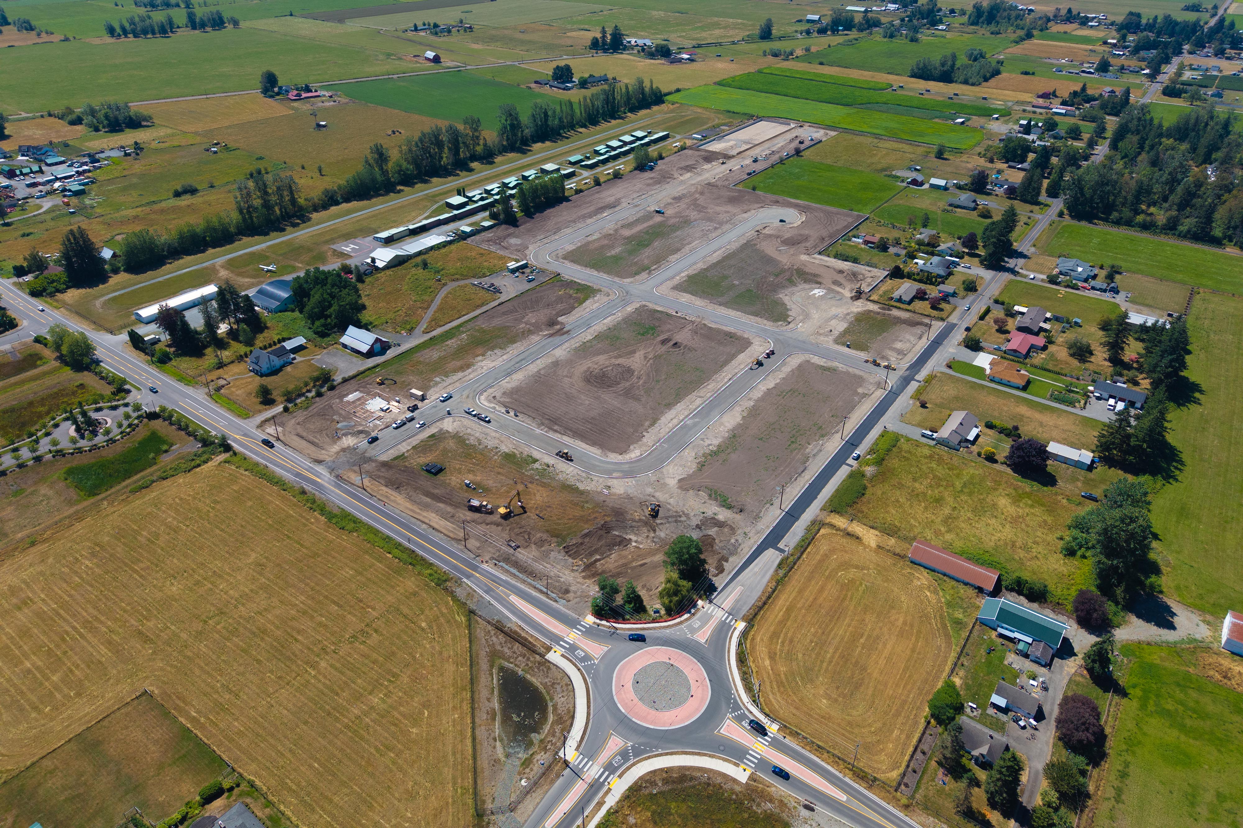 An aerial view of a road and a large area with trees.
