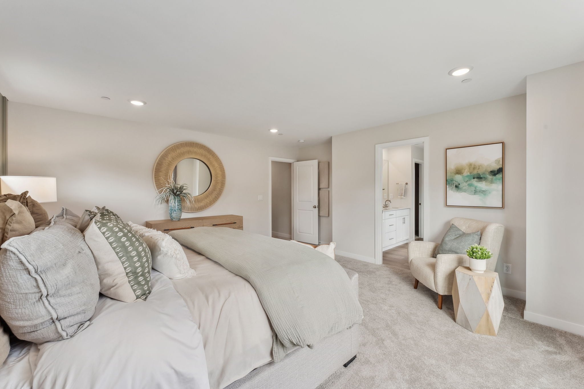 A large bedroom with a bed and a chair.