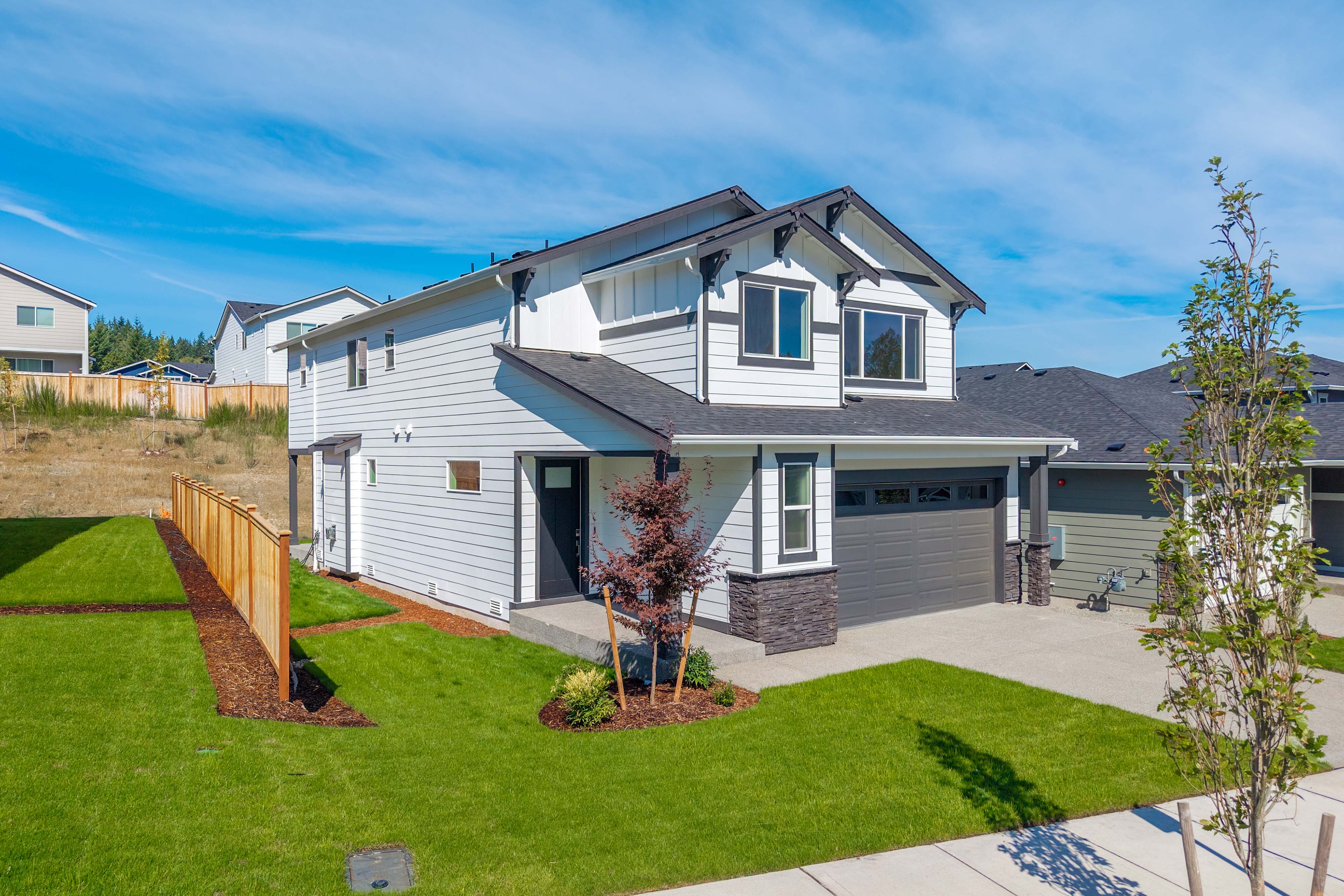 A house with a fence and yard.