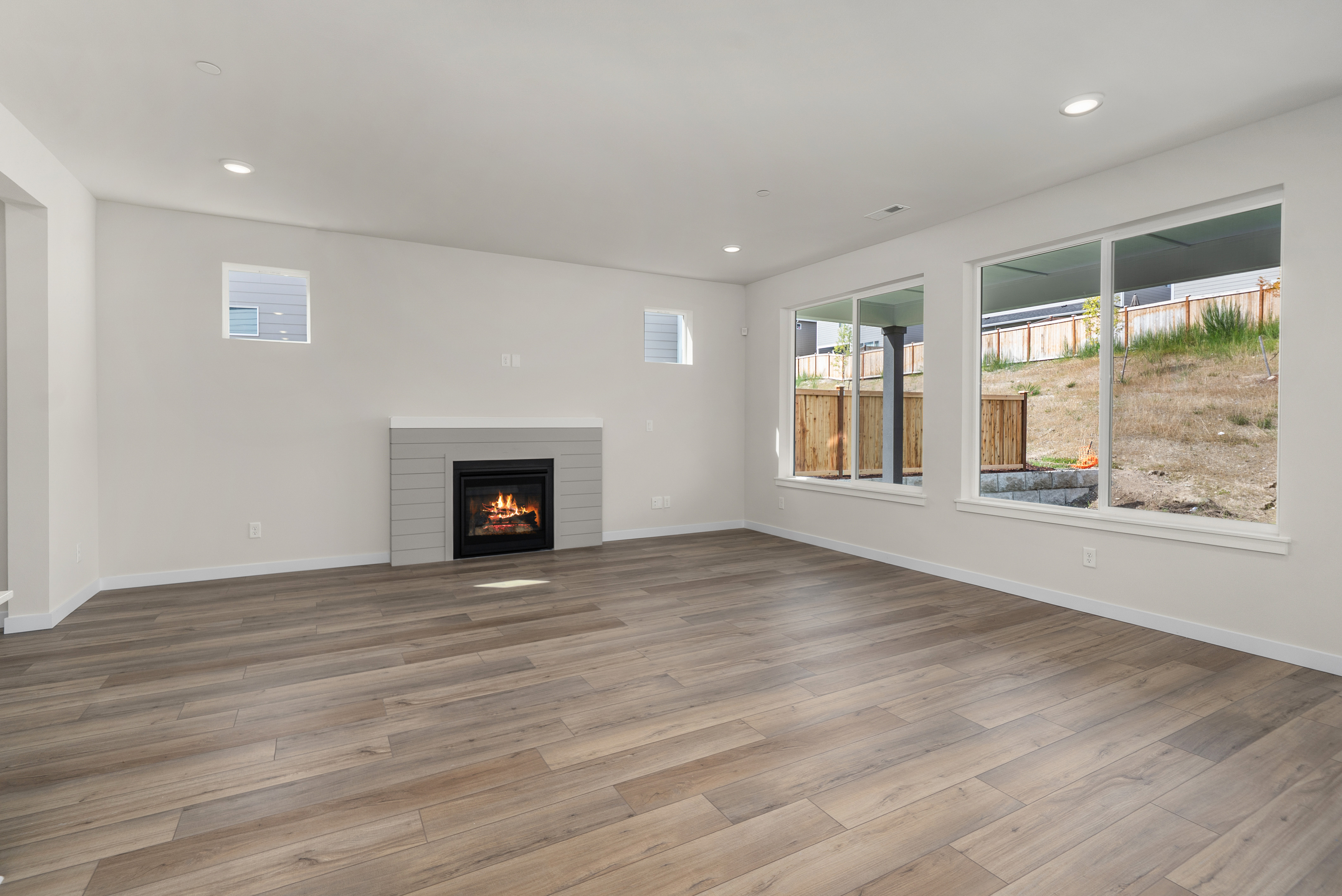 A room with a fireplace and windows.