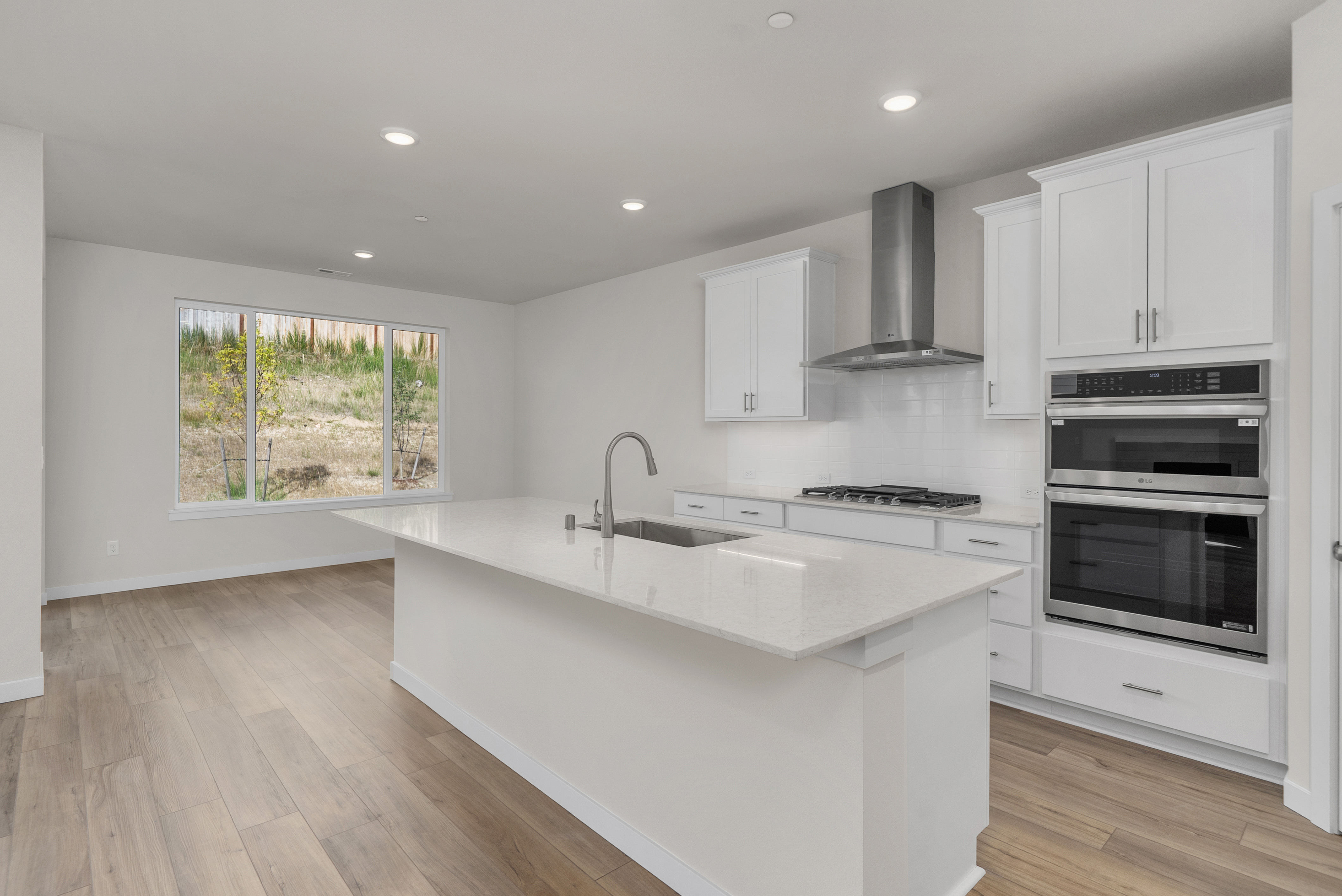 A kitchen with white cabinets.