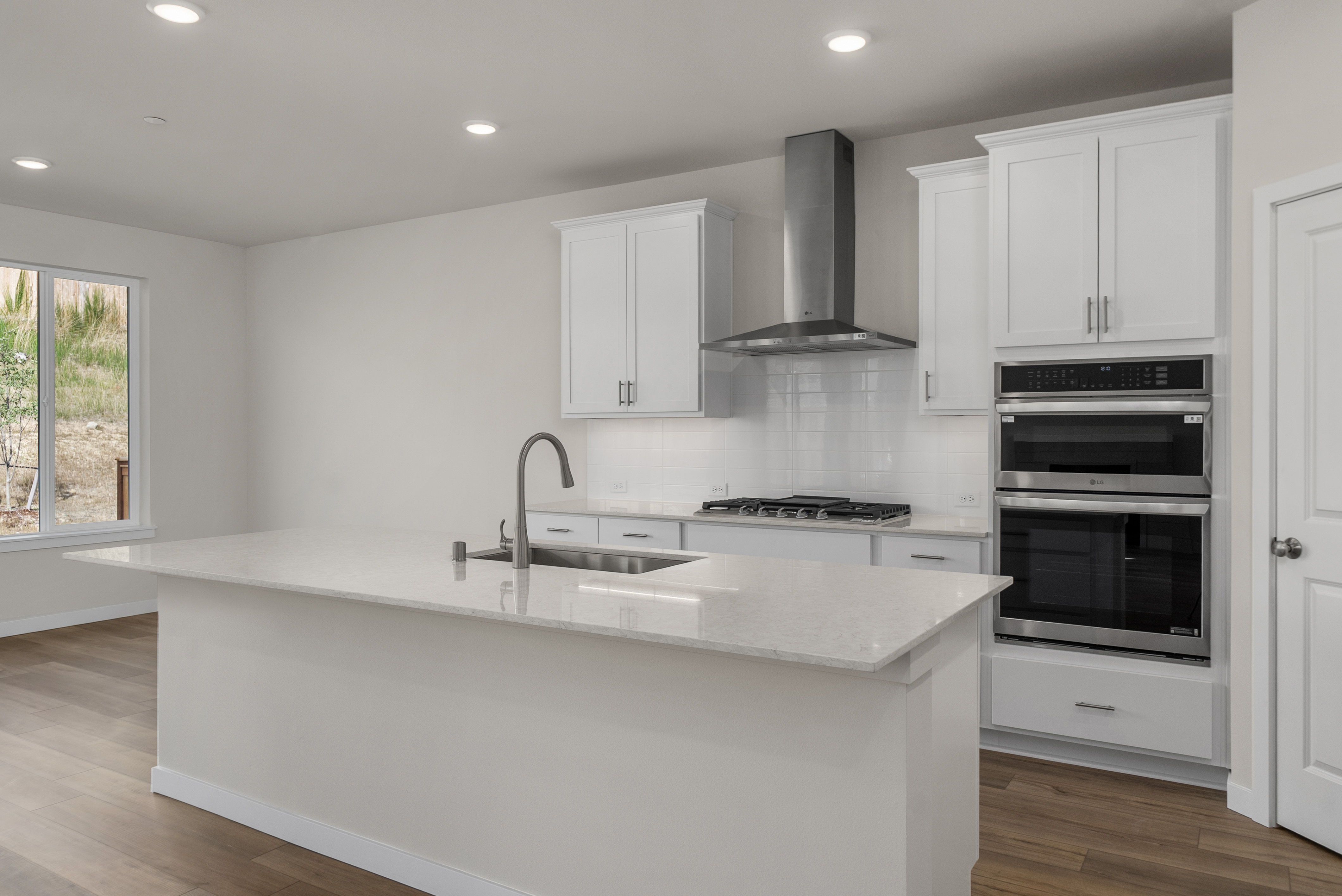 A kitchen with white cabinets.