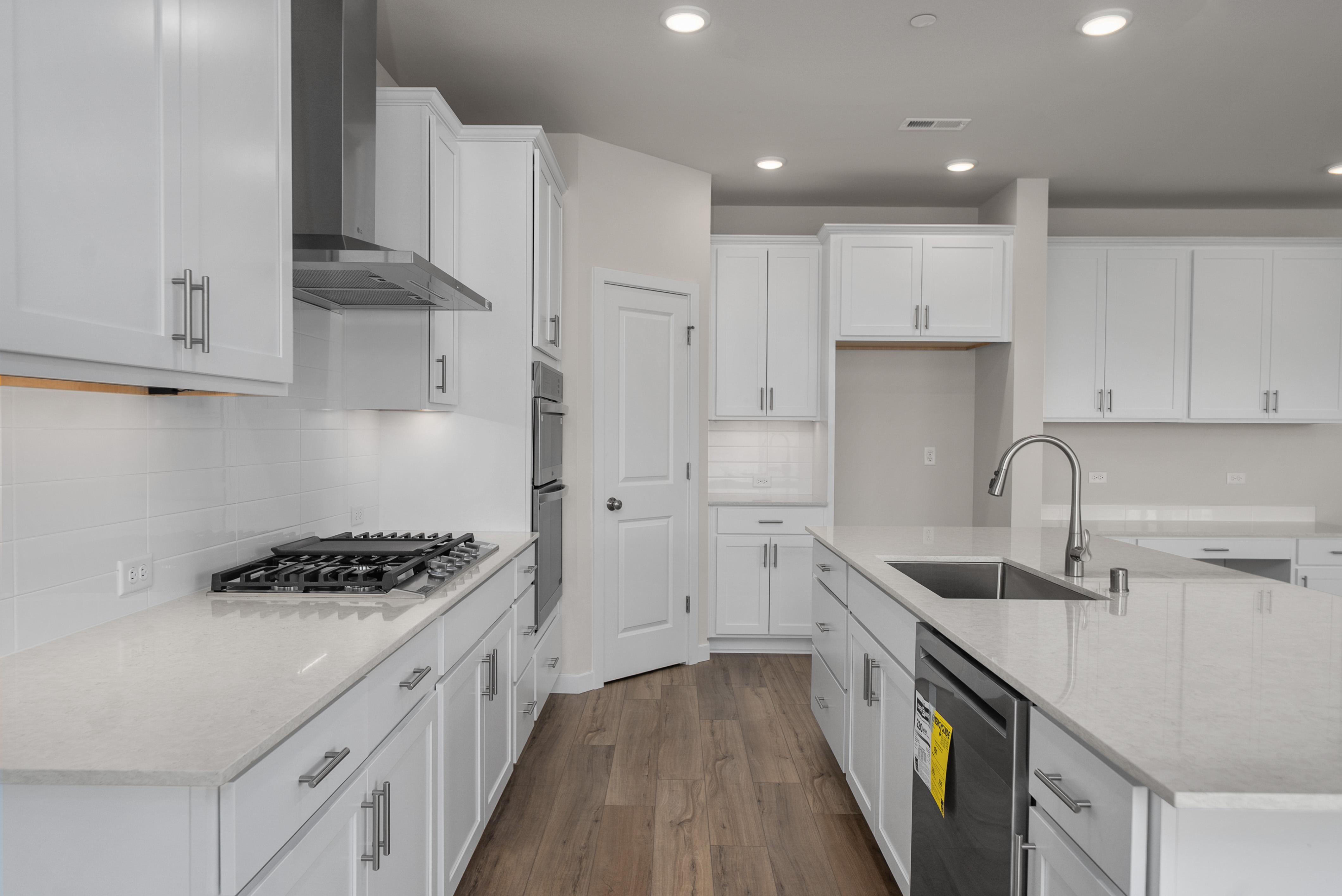 A kitchen with white cabinets.