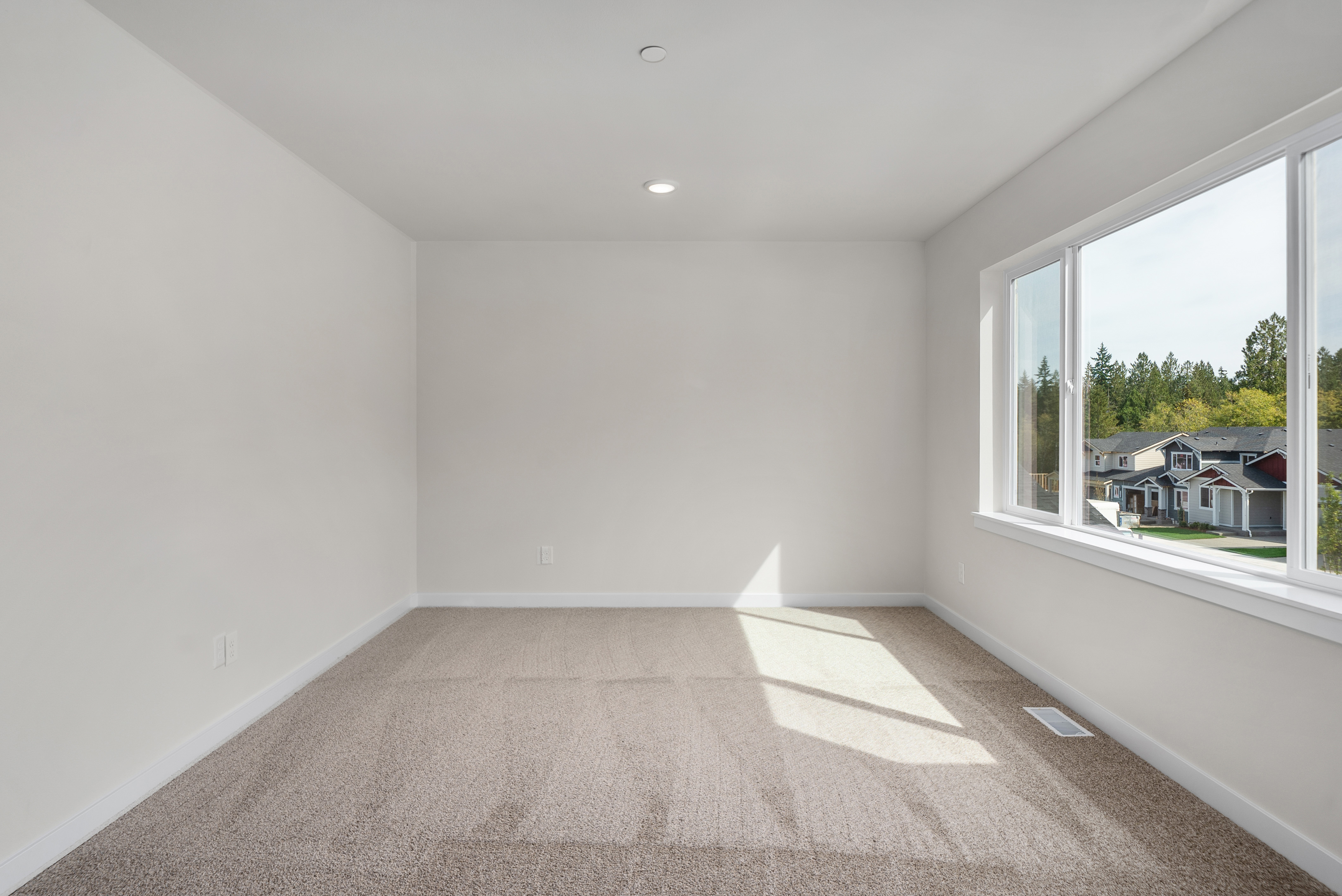 A room with a window and a carpet.