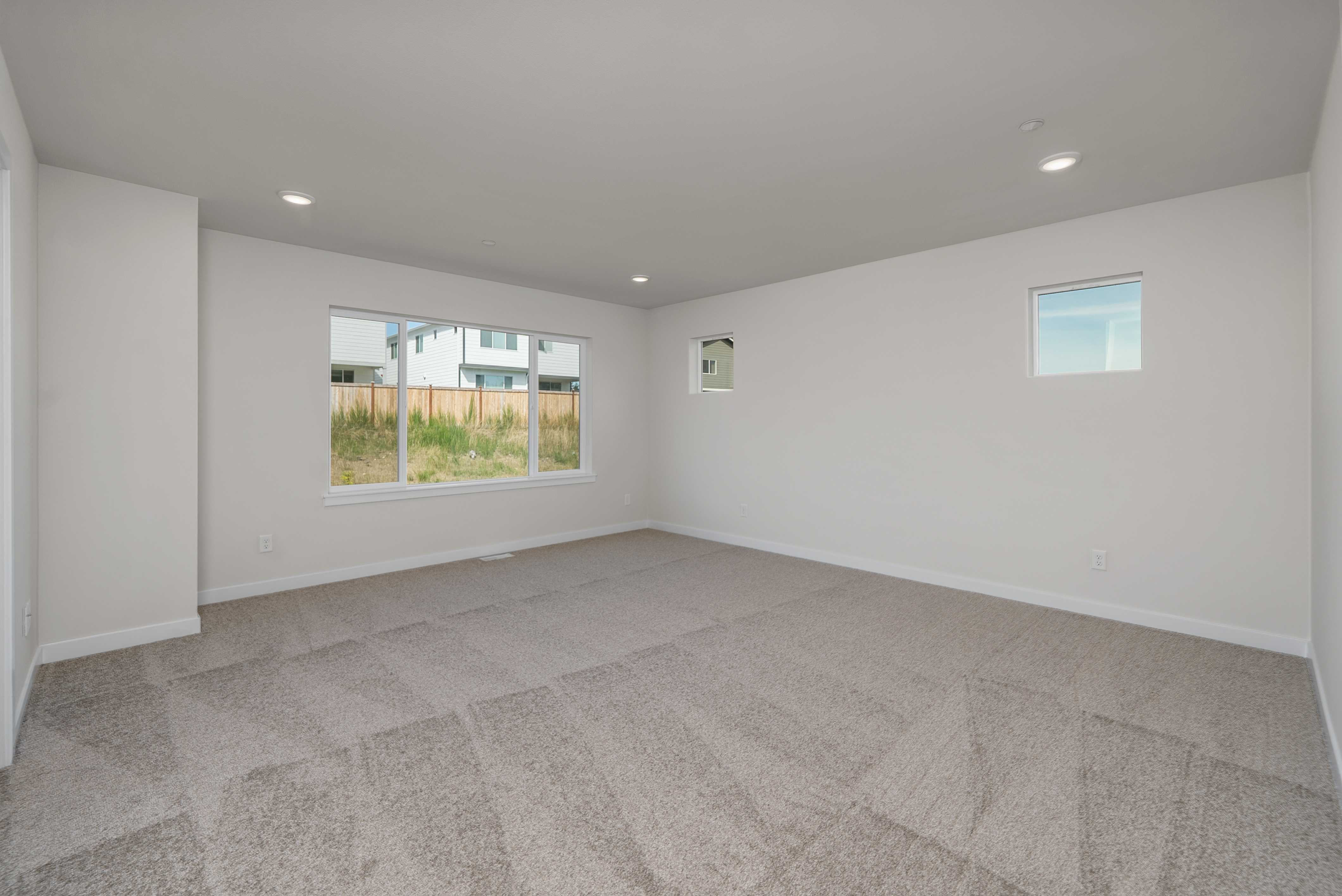 A room with a window and a rug.