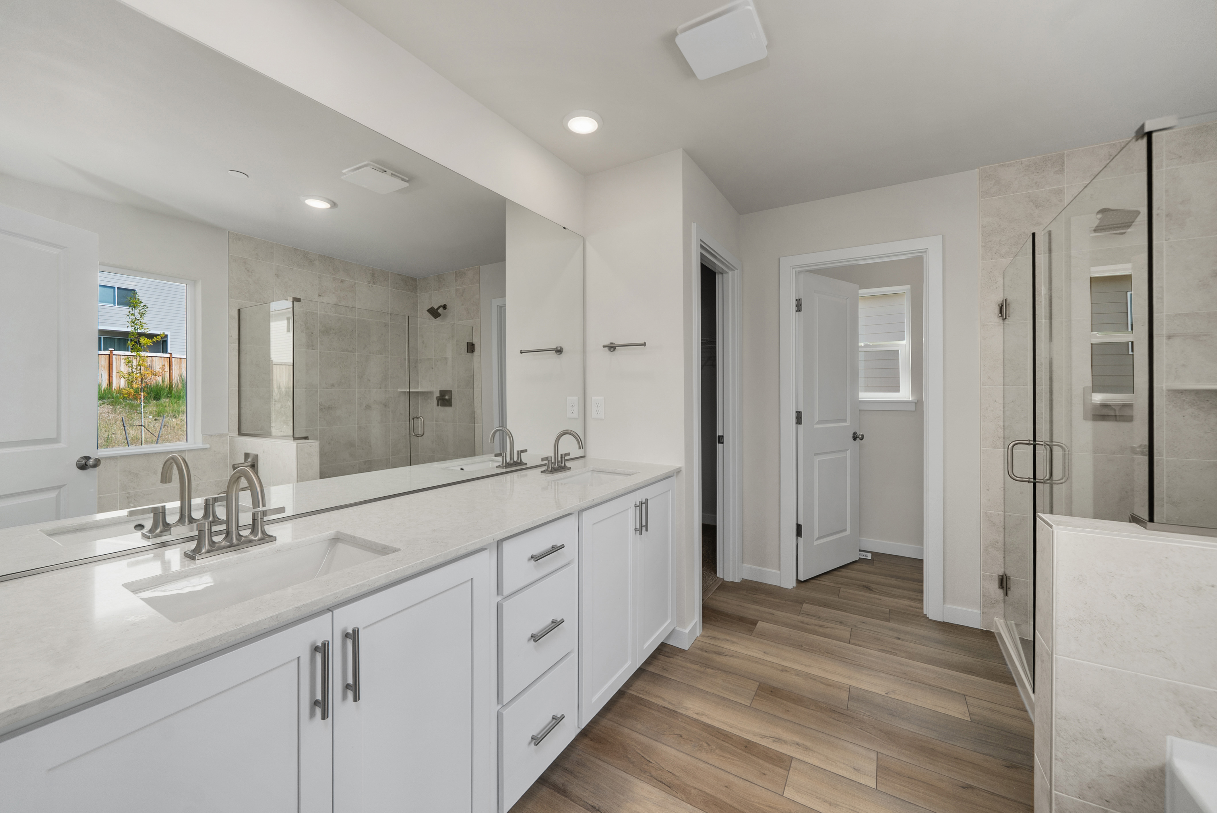 A bathroom with white cabinets.
