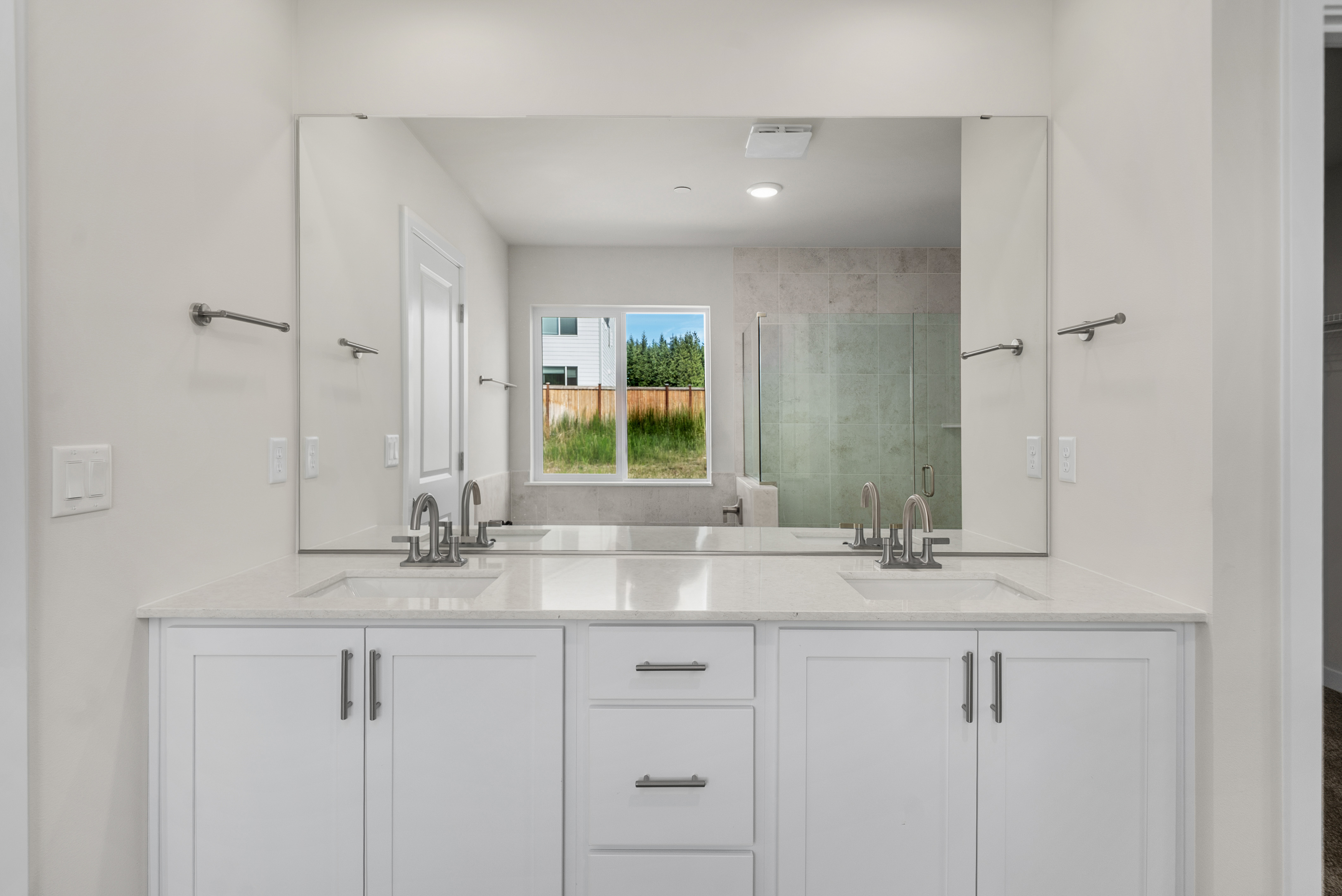 A kitchen with white cabinets.
