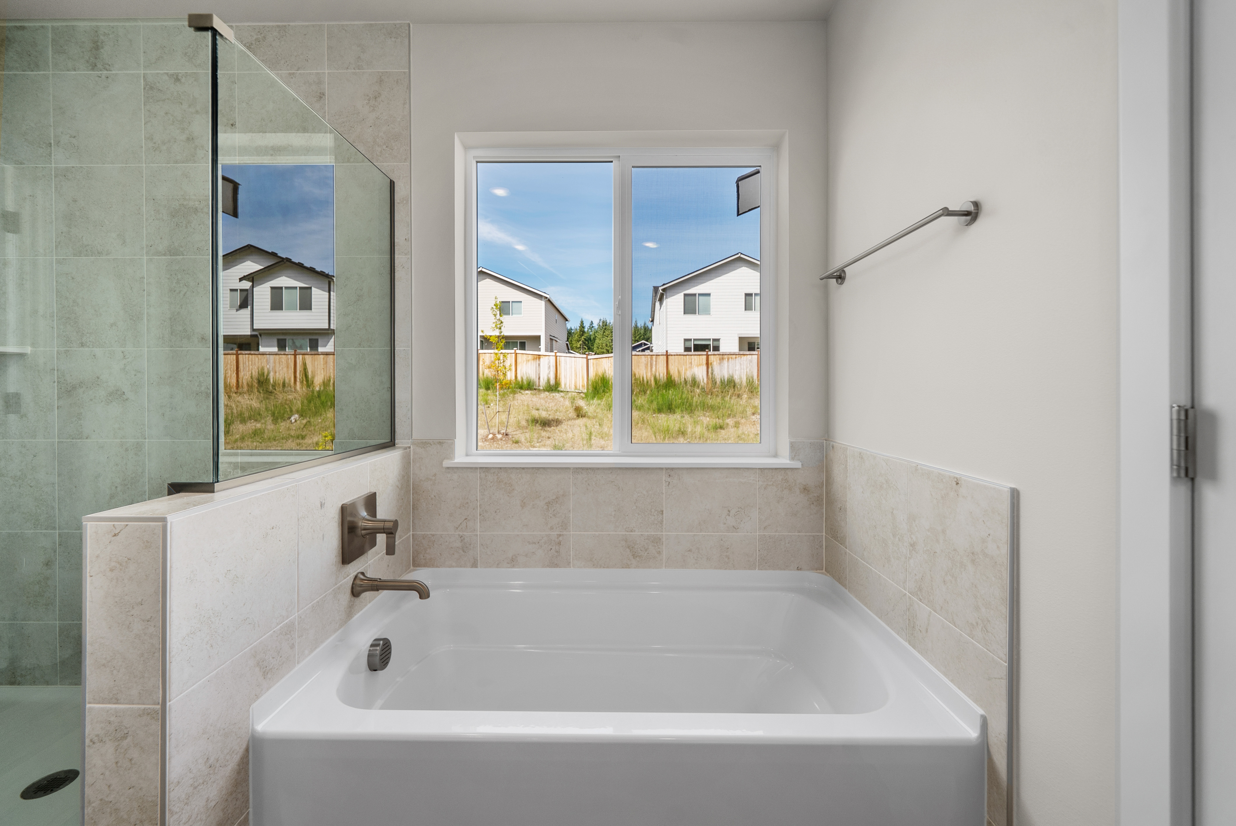 A bathroom with a tub and a window.