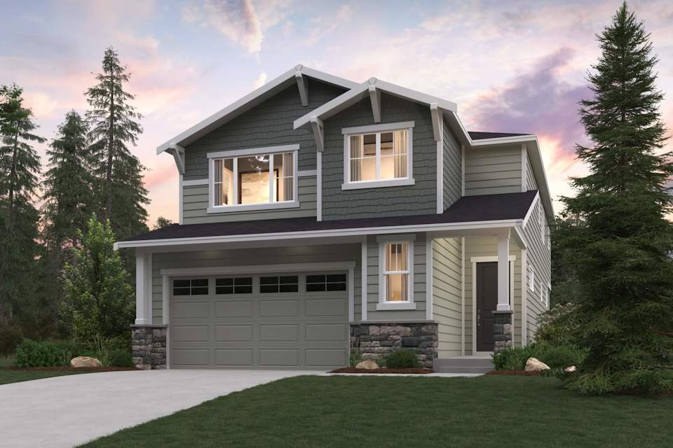 A house with a garage and trees around it.