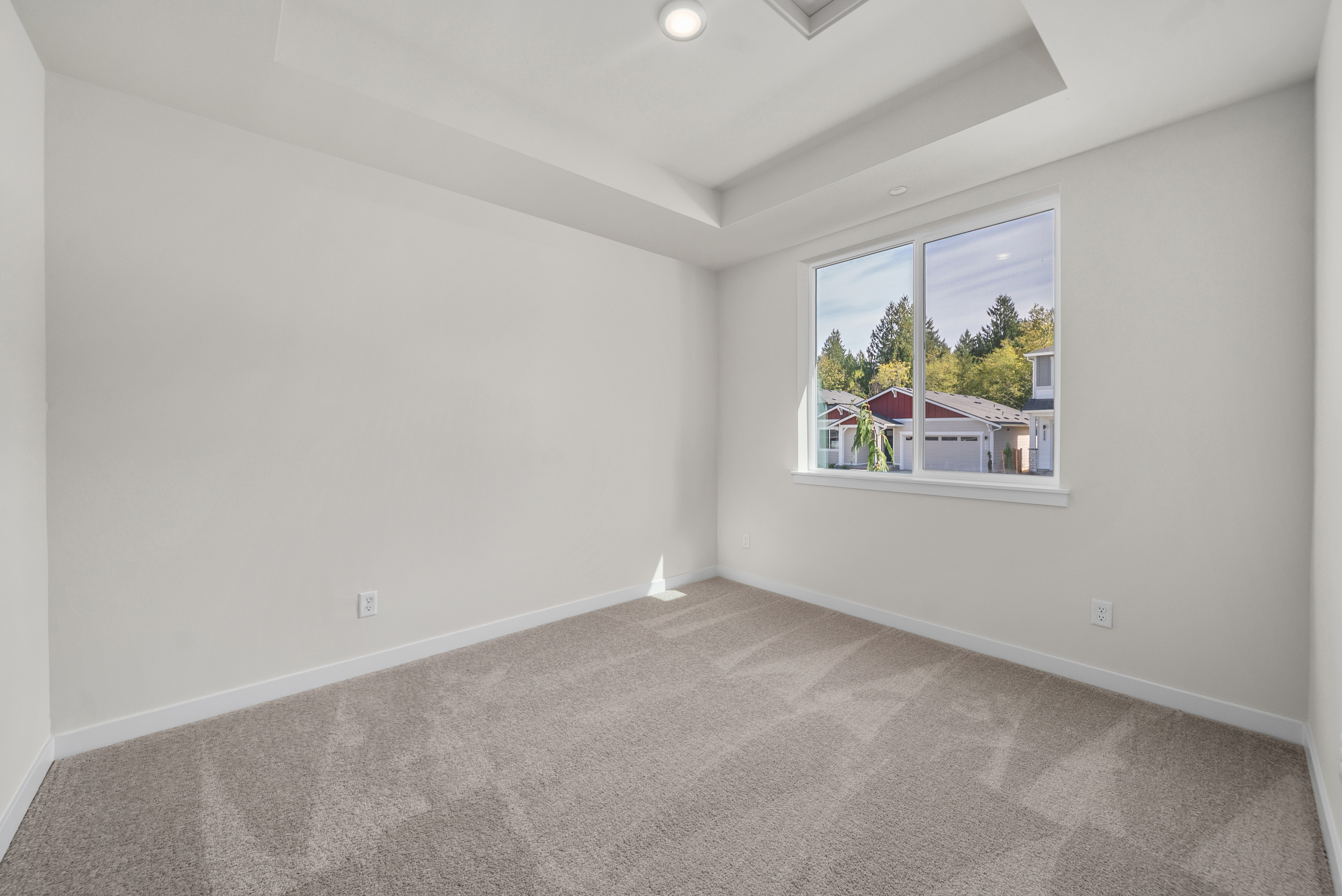 A room with a window and a carpet.