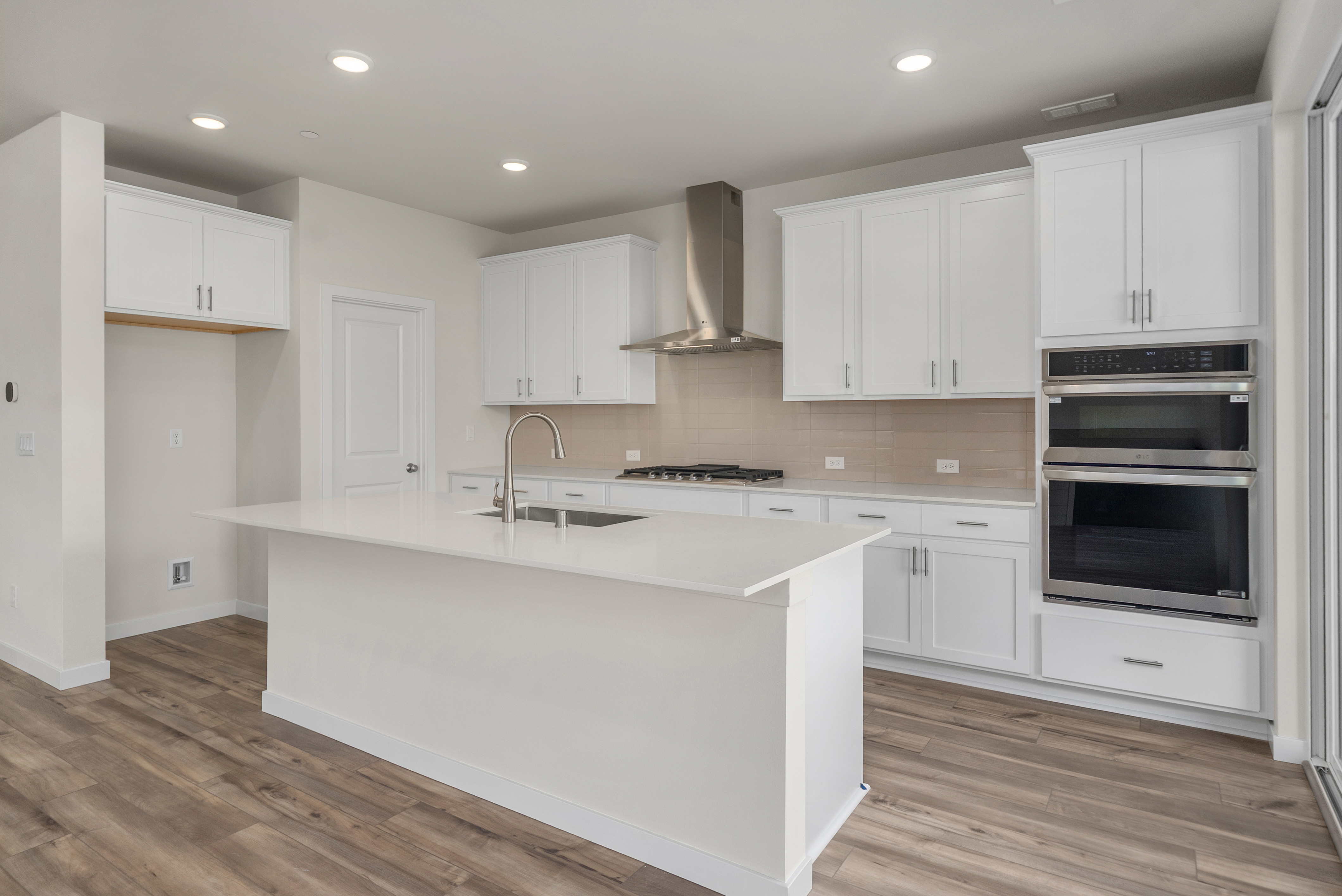 A kitchen with white cabinets.