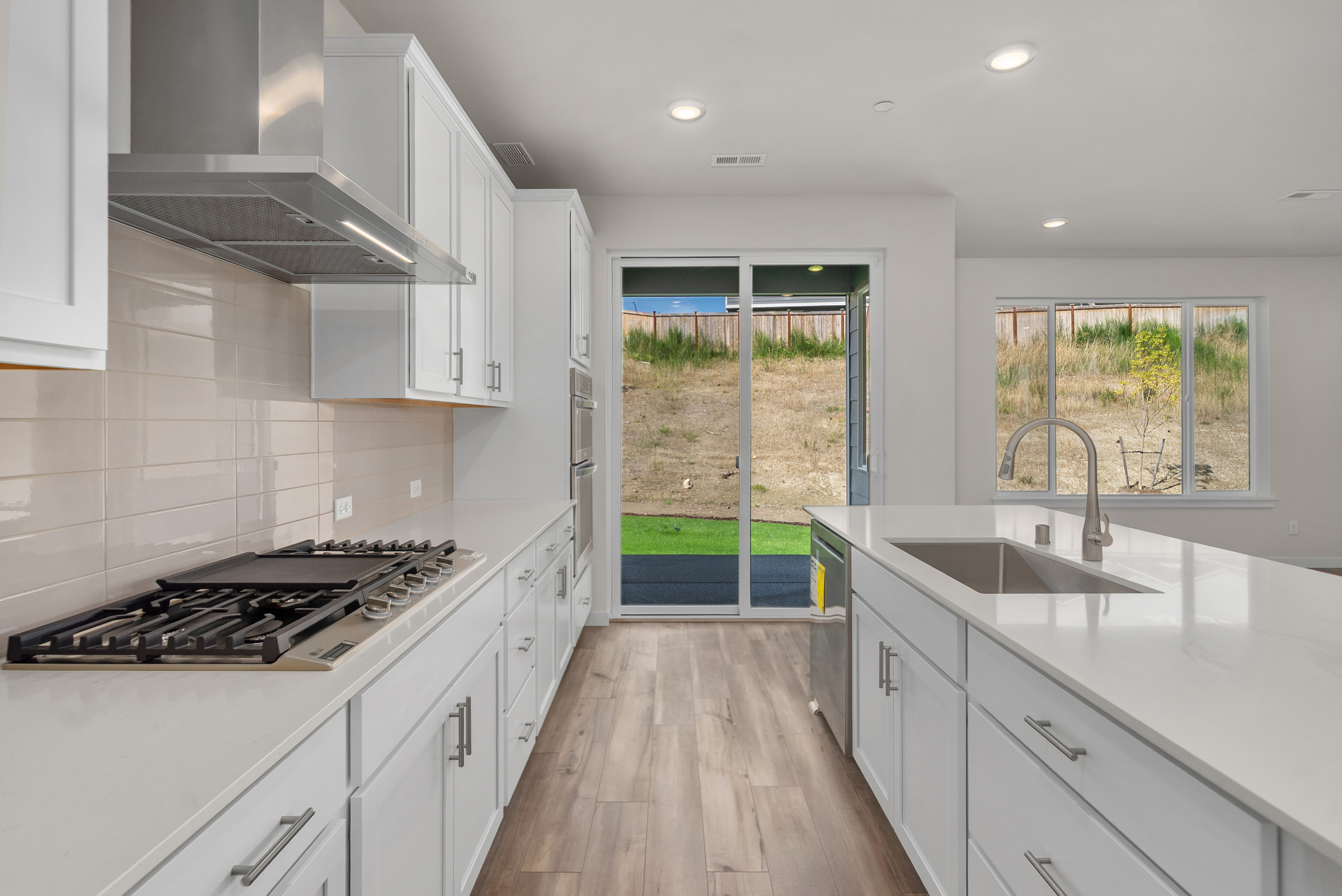 A kitchen with white cabinets.