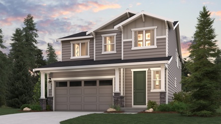 A house with a garage and trees around it.