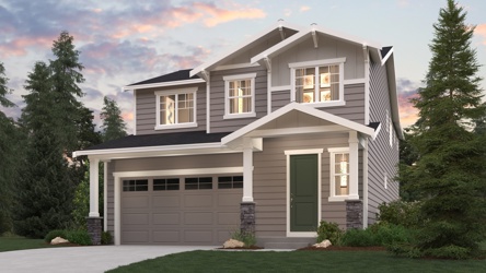 A house with a garage and trees around it.