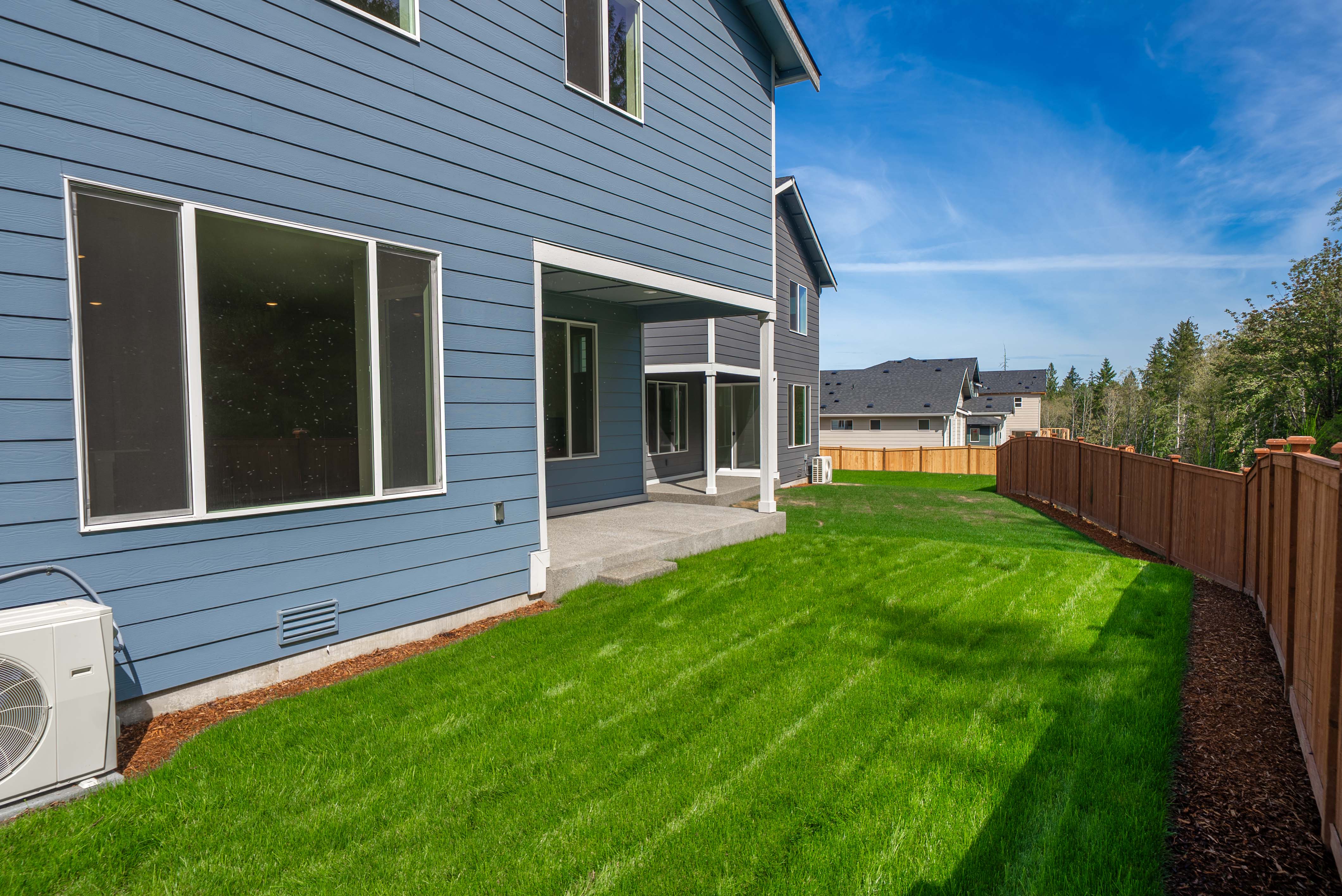 A house with a fence and grass.