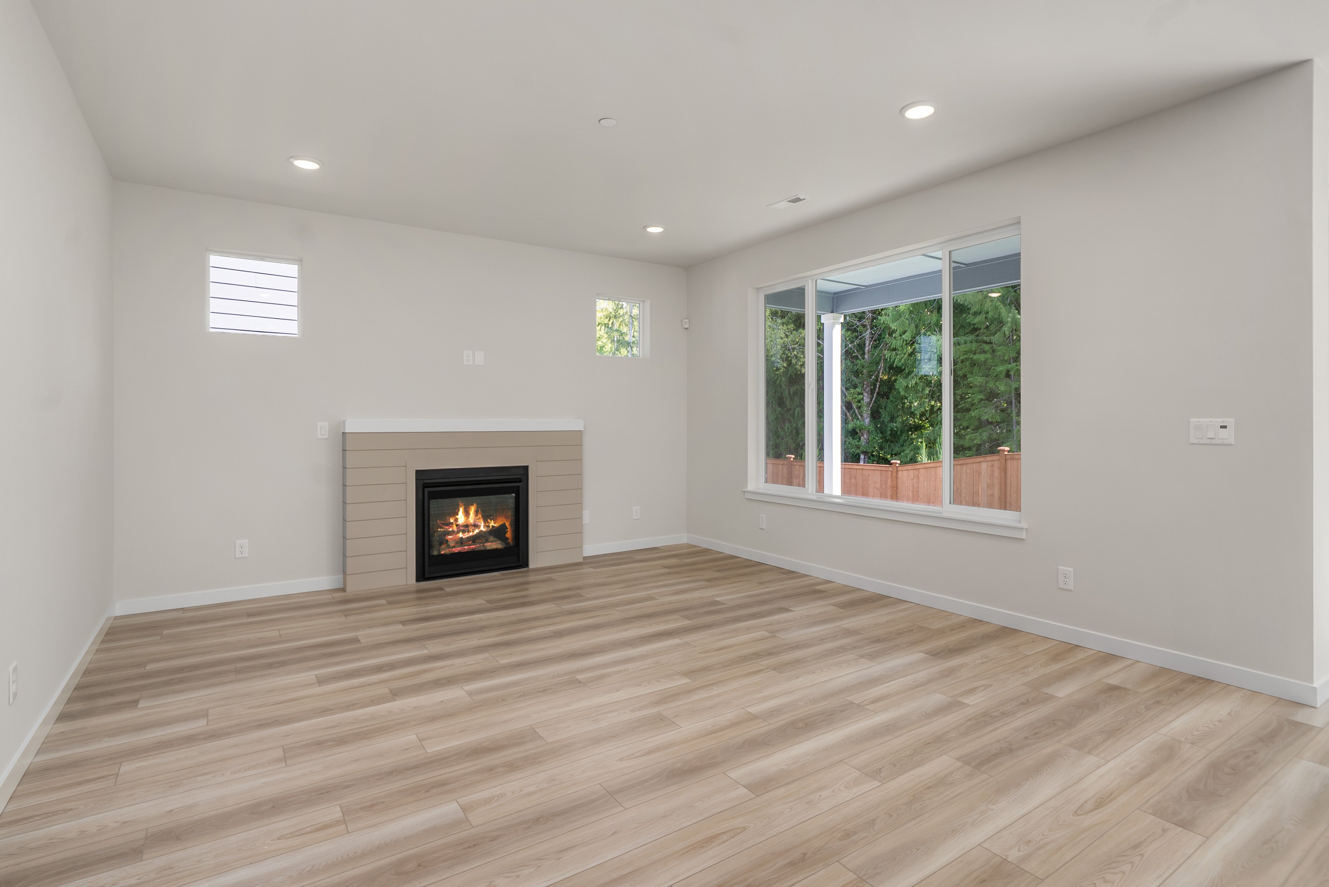 A room with a fireplace and a wood floor.