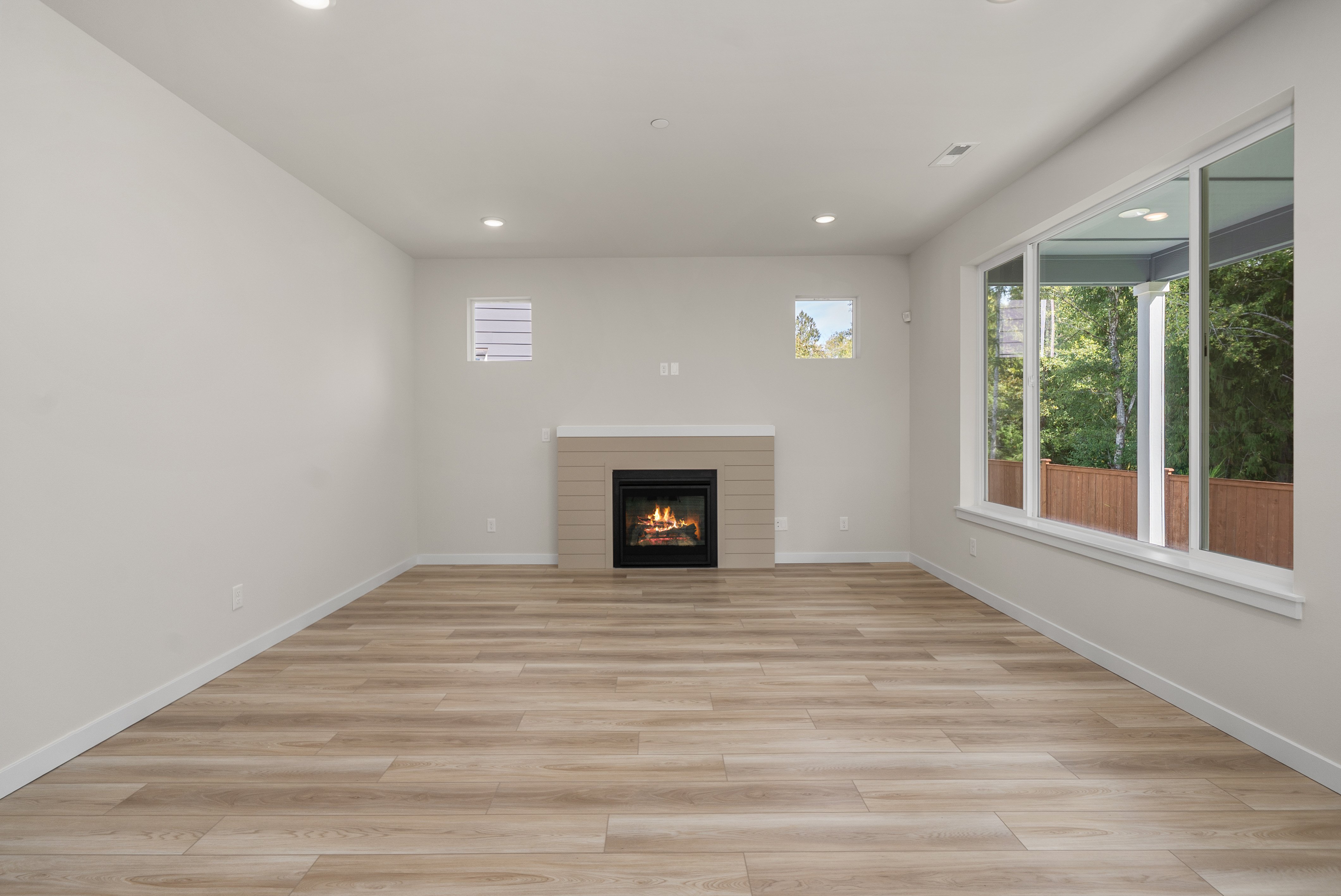 A room with a fireplace and a wood floor.