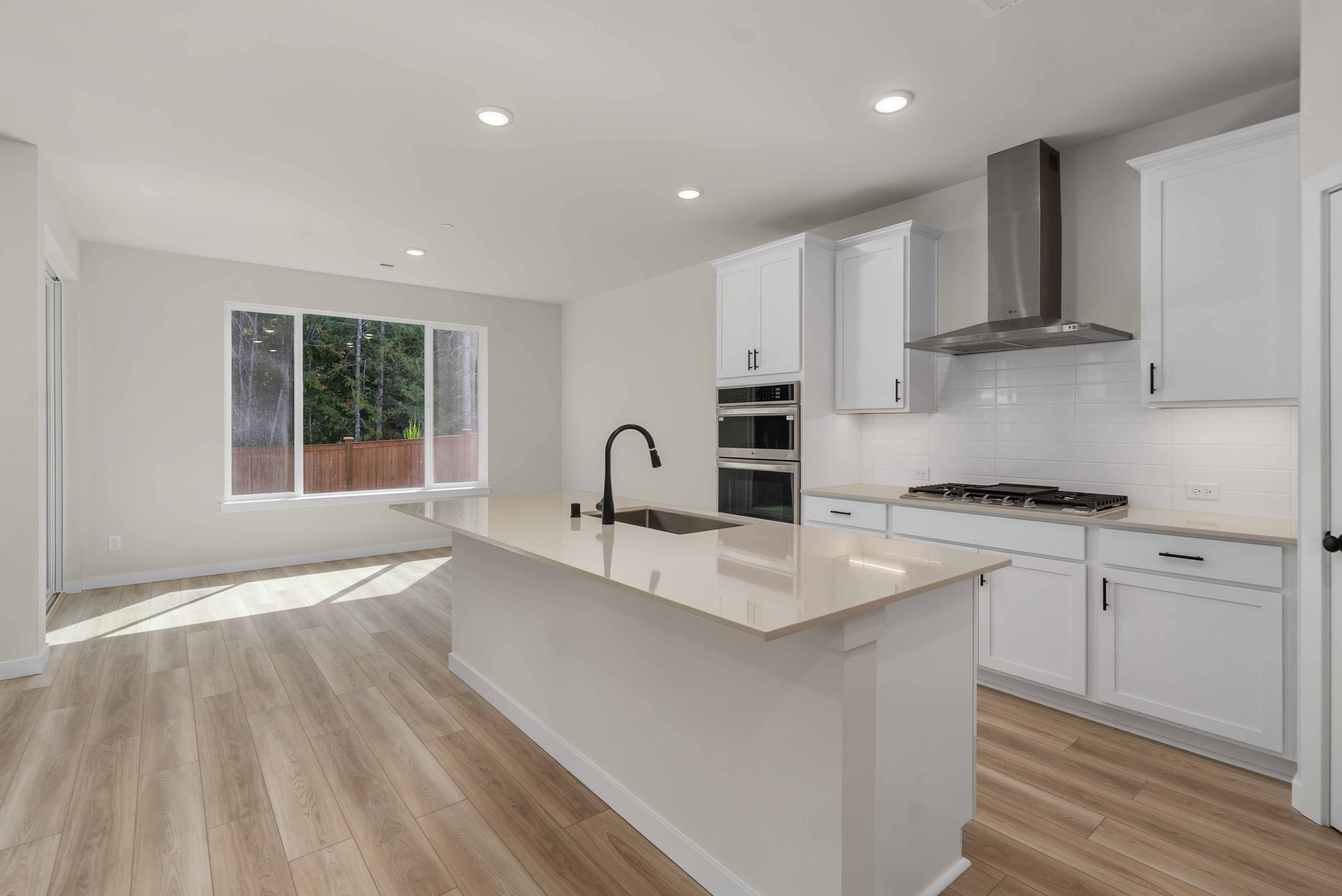 A kitchen with white cabinets.